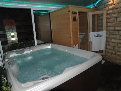 a jacuzzi bathtub in a room with a building at Apartments and bungalows vila Dalibor in Nin