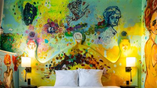 a bedroom with a painting on the wall at ART Hotel Dalgas, BW Signature Collection in Brande