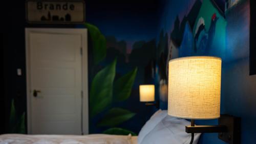 a lamp sitting on a bed in a room at ART Hotel Dalgas, BW Signature Collection in Brande