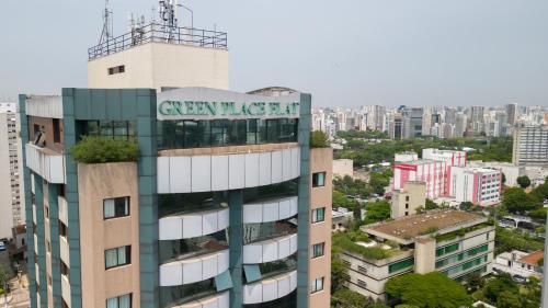 a tall building with a sign on top of it at Green Place Ibirapuera in São Paulo