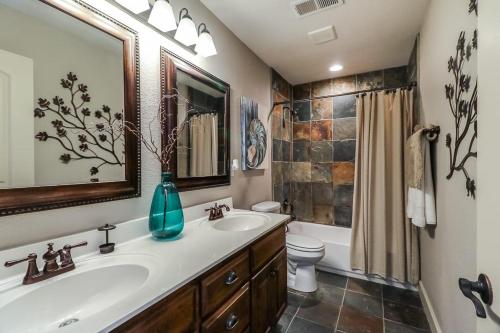 a bathroom with a sink and a toilet and a mirror at Amazing Locale 2KingBR 1BTH in Kansas City