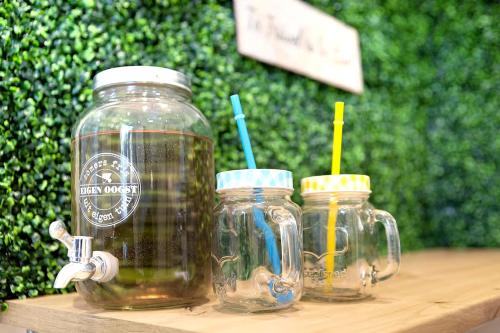 two mason jars on a wooden table with straws in them at Küstenzauber - Balkon - Tolle Lage - Netflix in Wilhelmshaven