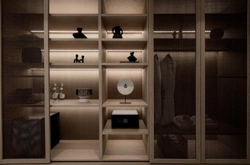 een kamer met een boekenplank met een lamp erop bij Enigma Mykonos Hideaway Suites in Ornos