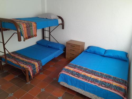 a room with two bunk beds and a chair at Quinta Maria in Fusagasuga