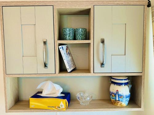 a cabinet with a shelf with items in it at Los Jameos in Scarborough
