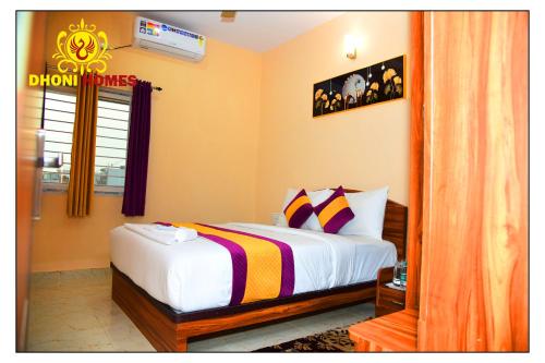 a bedroom with a bed and a window at Dhoni Homes -Premium 1 BHK Service Apartment Manyata Tech Park in Bengaluru