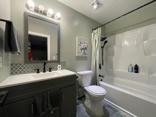 a bathroom with a sink and a toilet and a tub at Lake front house 4 beds 3baths in Agoura Hills
