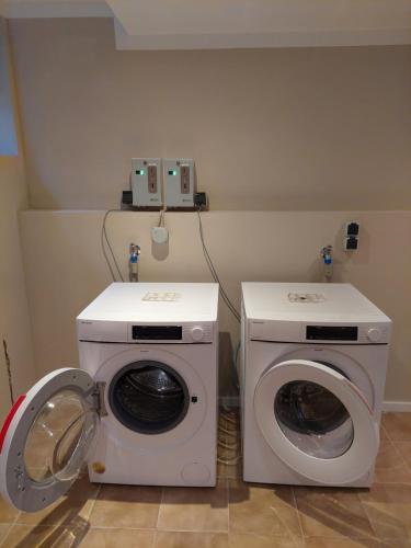 a laundry room with a washing machine and a washer at Bocksberg-Lodge in Goslar