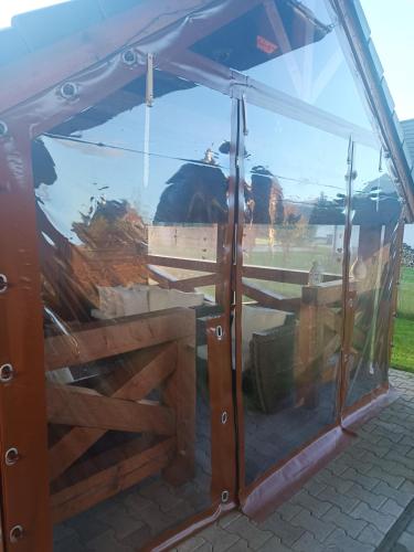 a glass door on a trailer with a fence at MJ Vila in Stará Lesná
