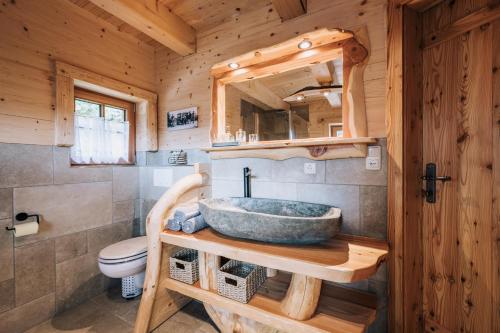a bathroom with a sink in a log cabin at Webertonihütte in Bad Sankt Leonhard im Lavanttal