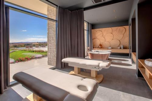 a master bathroom with a sink and a bathtub at KatarzynA Hotel in Svilengrad
