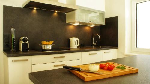 a kitchen with a cutting board with tomatoes on a counter at MOUNTAIN HOME apartment in Finkenberg