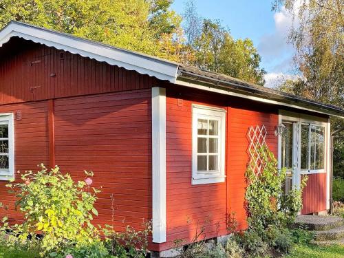 a small red house with two windows at 4 person holiday home in TORUP in Torup