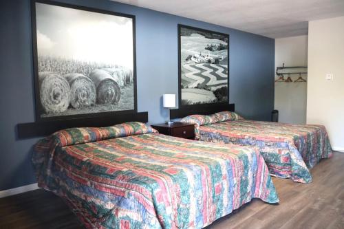 a hotel room with two beds and a painting on the wall at Hotel O Oskaloosa Near Eddyville in Oskaloosa