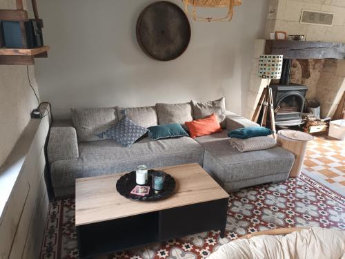 a living room with a couch and a coffee table at D'une rive à l'autre in Francueil