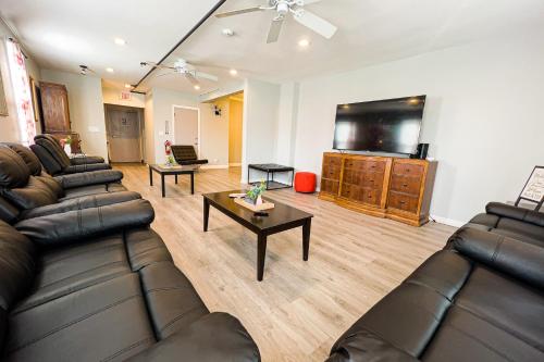a living room with couches and a flat screen tv at Unique Large 9BR House with 3 Bath Close to the falls in Niagara Falls