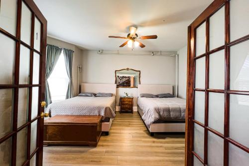 a bedroom with two beds and a ceiling fan at Unique Large 9BR House with 3 Bath Close to the falls in Niagara Falls