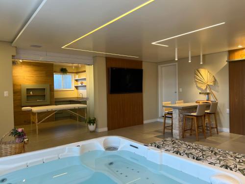 a large bathroom with a bath tub in a room at Chalé Alto da Serra - Pousada & Wellness Spa in São Joaquim