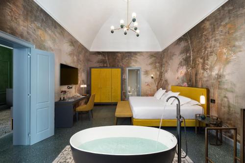 a bedroom with a bed and a bath tub at VIS Urban Suites&Spa in Bari