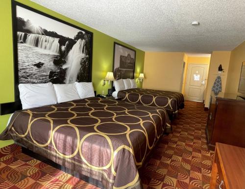 a hotel room with a large bed in it at Super 8 by Wyndham Lake of the Ozarks in Eldon