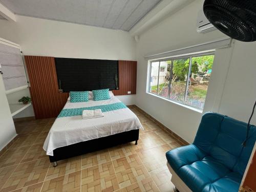 En eller flere senger på et rom på Cabaña Santorini Colombiano