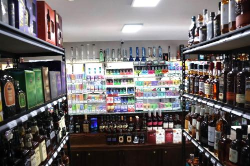 a store filled with lots of bottles of alcohol at Hotel O Oskaloosa Near Eddyville in Oskaloosa
