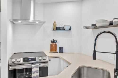 a kitchen with a sink and a stove at Downtown Luxury 1BR Coal Harbour in Vancouver