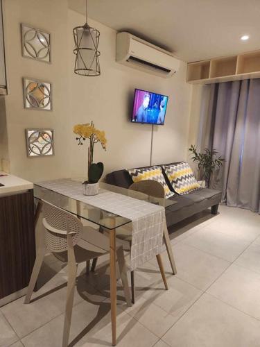 a living room with a table and a couch at Tambuli maribago residence in Lapu Lapu City