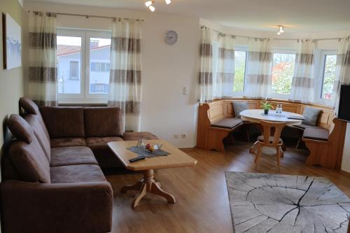 a living room with a couch and a table at Gästehaus Sonner in Dietmannsried