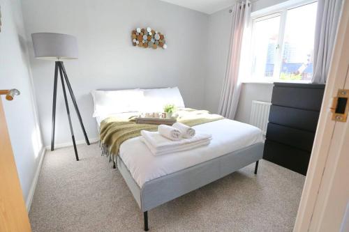 a bedroom with a bed with towels on it at Luxurious Townhouse In Central Manchester in Manchester