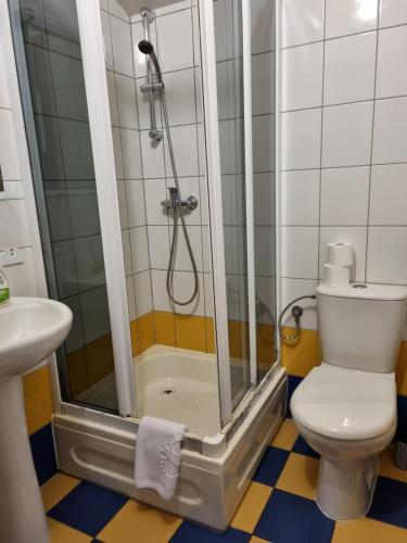 a bathroom with a shower with a toilet and a sink at Zajazd Bazylia in Ozorków