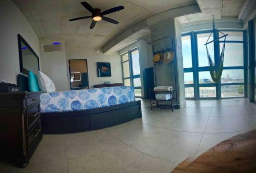 a living room with a couch and a ceiling fan at Atlantis Spacious Loft-Sea view in San Juan