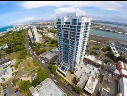 an aerial view of a city with a tall building at Atlantis Spacious Loft-Sea view in San Juan