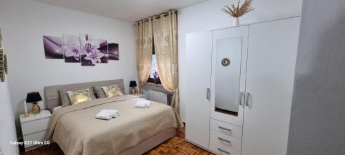 a bedroom with a bed with two towels on it at YUDI HOUSE in Aosta