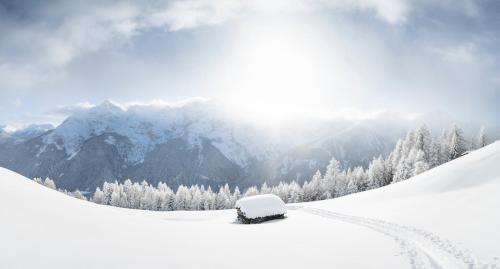 a car covered in snow on a snow covered mountain at Ferienwohnung Robi in Fulpmes