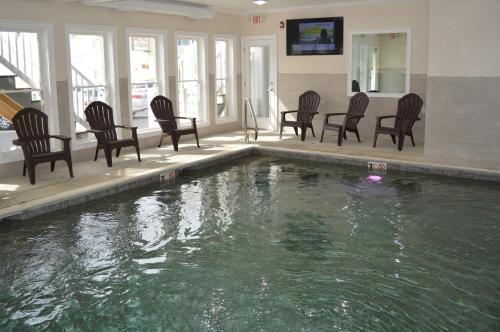 a group of chairs and a pool in a house at Copley LaReine Motel in Old Orchard Beach