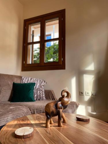 a wooden toy dog on a table in a living room at Delfi's cozy maisonette in Delfoi