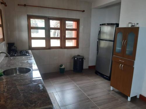a kitchen with a sink and a refrigerator at EcoCasa Romantica vista a Cali disfruta en pareja o familia in Yumbo