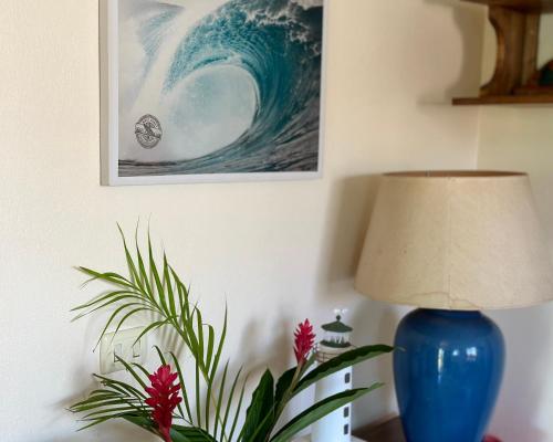 a blue vase sitting on a table next to a lamp at The Inner Light Yoga Lodge in Sámara