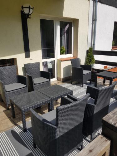 a group of tables and chairs on a patio at Szymonówka W Szklarskiej Porębie in Szklarska Poręba