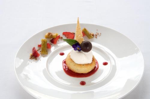 a white plate with a dessert on a table at Seilers Vintage Hotel & Spa in Kandersteg