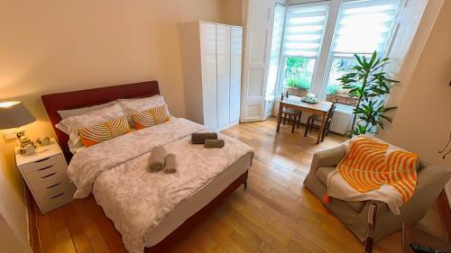 a bedroom with a bed and a chair and a window at Lovely&Bright Studio Flat Close to Central London in London