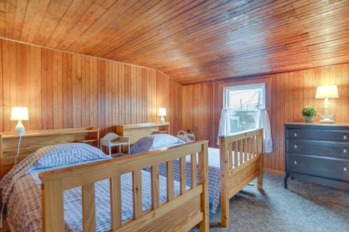 a bedroom with two beds and a wooden ceiling at Historic Cottage w/ Beautiful Oceanfront View in Marshfield