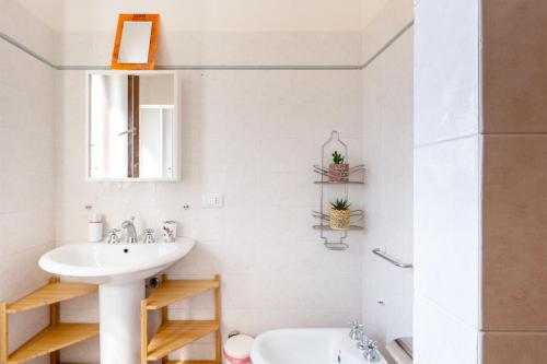 a white bathroom with a sink and a toilet at Villa Aura in Marina di Modica
