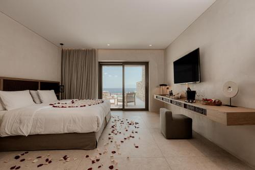 Una cama o camas en una habitación de Enigma Mykonos Hideaway Suites