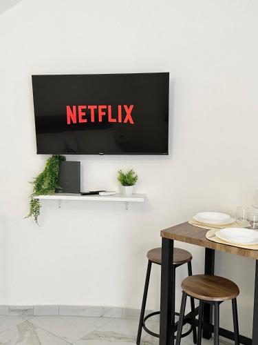 a tv on a wall with a netflix sign on it at Dimora Bianca in Catania