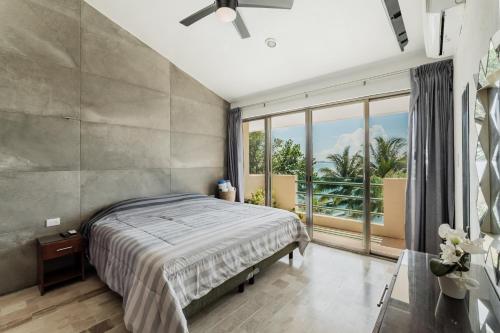 a bedroom with a bed and a large window at Seáak Cancun Rentals in Cancún