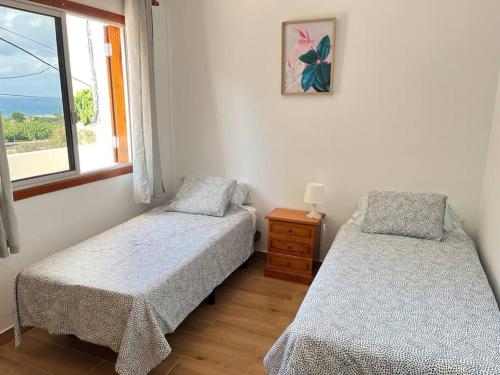 a bedroom with two beds and a window at Casa Palmar in Valle Gran Rey