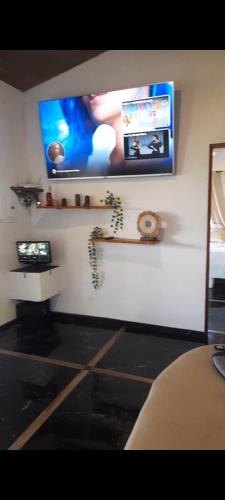 a room with a flat screen tv on a wall at Casa Namaste del Pacifico - Luxury Villa in Santa Teresa Beach
