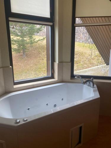 a white bath tub in a bathroom with a window at Shale Anemona in Bukovel